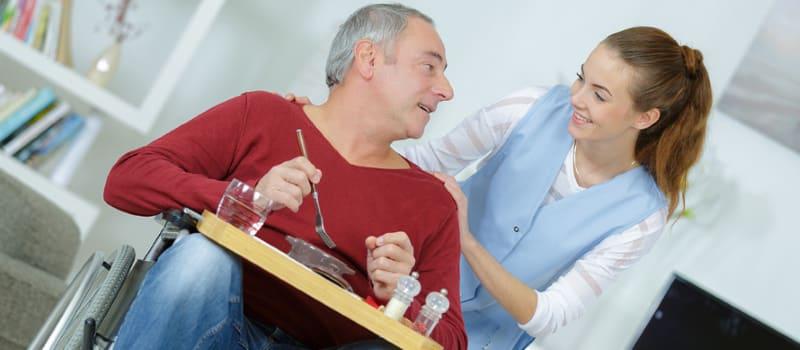 Support worker and participant preparing a meal together